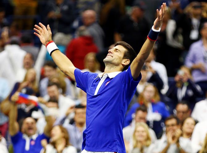 Serbia's Novak Djokovic celebrates after defeating Switzerland's Roger Federer to win the US Open title on Sunday