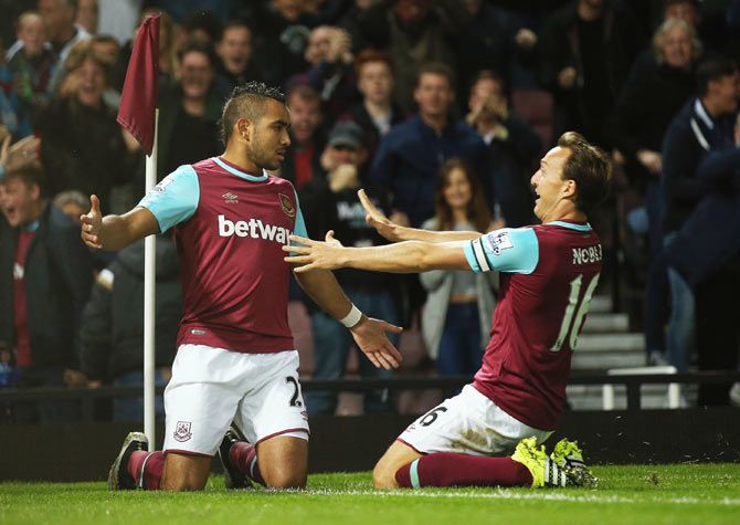 West Ham United's Dimitri Payet (lwft) celebrates with teammate Mark Noble after scoring the opening goal against Newcastle United during their English Premier League match at the Boleyn Ground in London on Monday