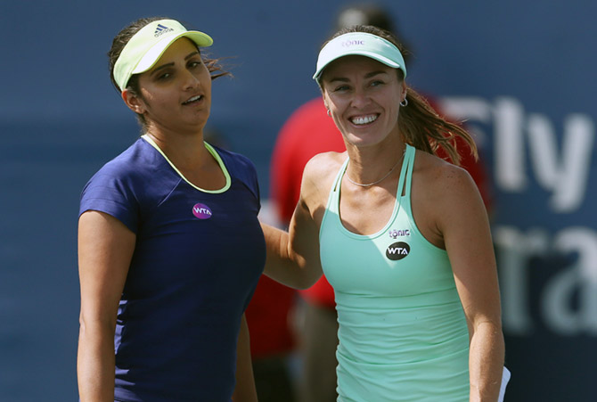 Sania Mirza of India and Martina Hingis of Switzerland congratulate each other