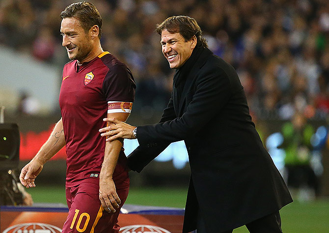 Francesco Totti of AS Roma laughs with coach Rudi Garcia 