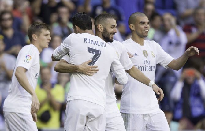  Real Madrid's Karim Benzema (2nd from right) celebrates with teammates Pepe (right), Cristiano Ronaldo and Toni Kroos (left) after scoring against Granada CF during their La Liga match at Estadio Santiago Bernabeu in Madrid on Saturday