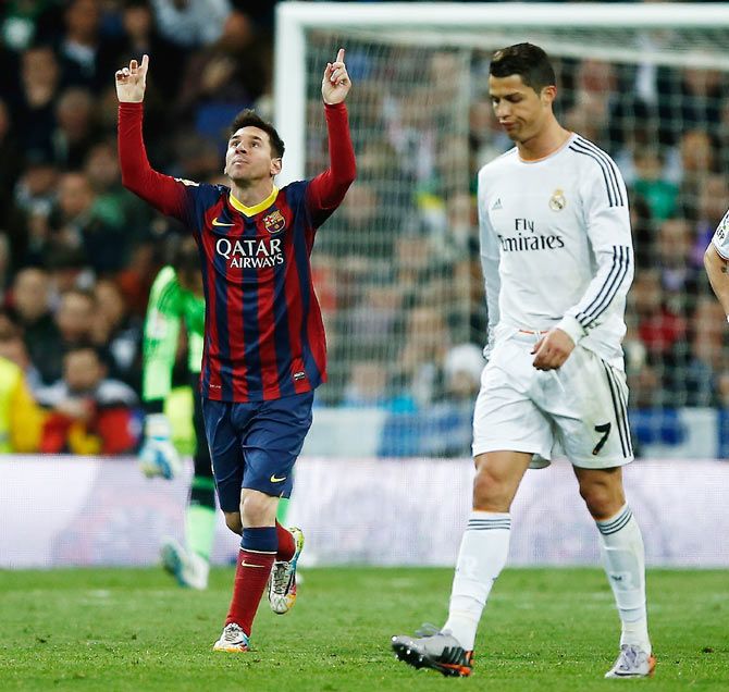 Lionel Messi (left) of Barcelona celebrates next to Real Madrid's Cristiano Ronaldo