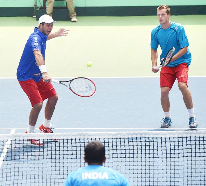 Czech Republic's Adam Pavlasek (right) and Radek Stepanek in action against India’s Rohan Bopanna and Leander Paes during their doubles tennis match at the Davis Cup World Group play-off tie in New Delhi on Saturday