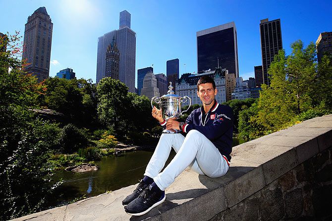 Serbia's Novak Djokovic the 2015 US Open Men's champion poses with the winner's trophy in Central Park in New York City on Monday