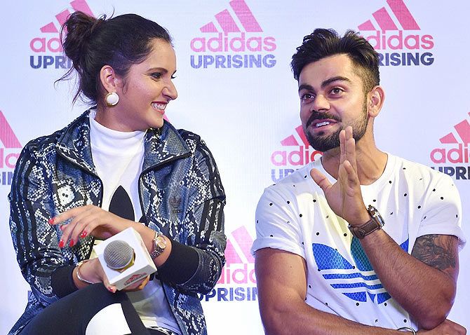 Tennis Star Sania Mirza and Indian Cricketer Virat Kohli chat during the launch of an Adidas showroom in Bengaluru on Saturday