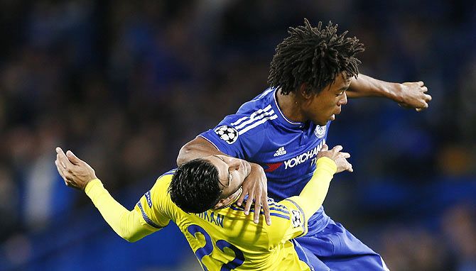 Chelsea's Loic Remy and Tel Aviv's Avi Rikan vies for possession during their UEFA Champions League Group G match at Stamford Bridge in London on Wednesday, September 16