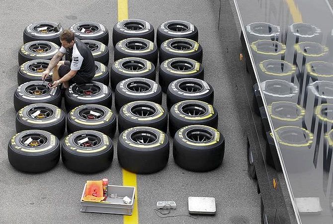 A Mercedes mechanic checks the pressure of Pirelli tyres ahead of the Italian F1 Grand Prix in Monza