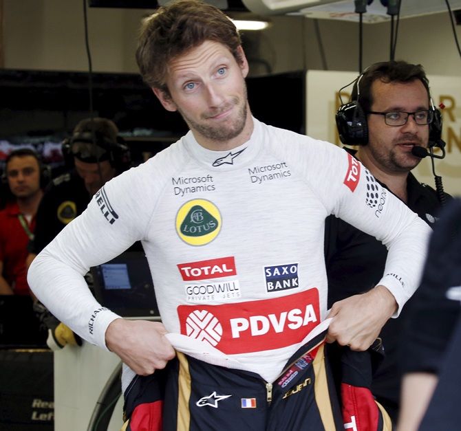 Formula One driver Romain Grosjean of France reacts in the team garage