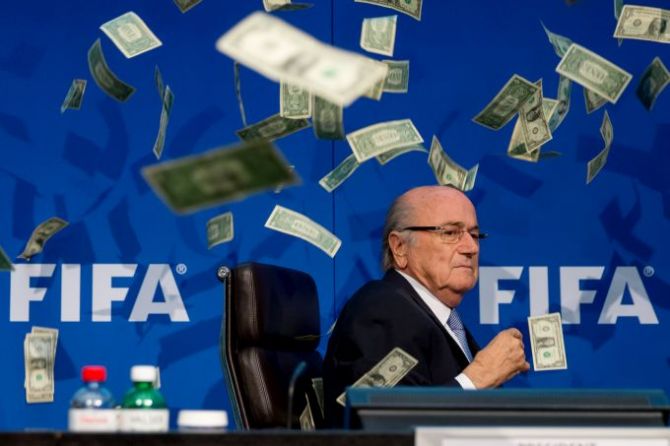 British comedian Simon Brodkin (not pictured) throws cash at FIFA president Sepp Blatter, interrupting his speech during a press event in Zurich on July 20