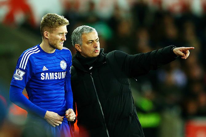 Chelsea manager Jose Mourinho speaks with Andre Schuerrle