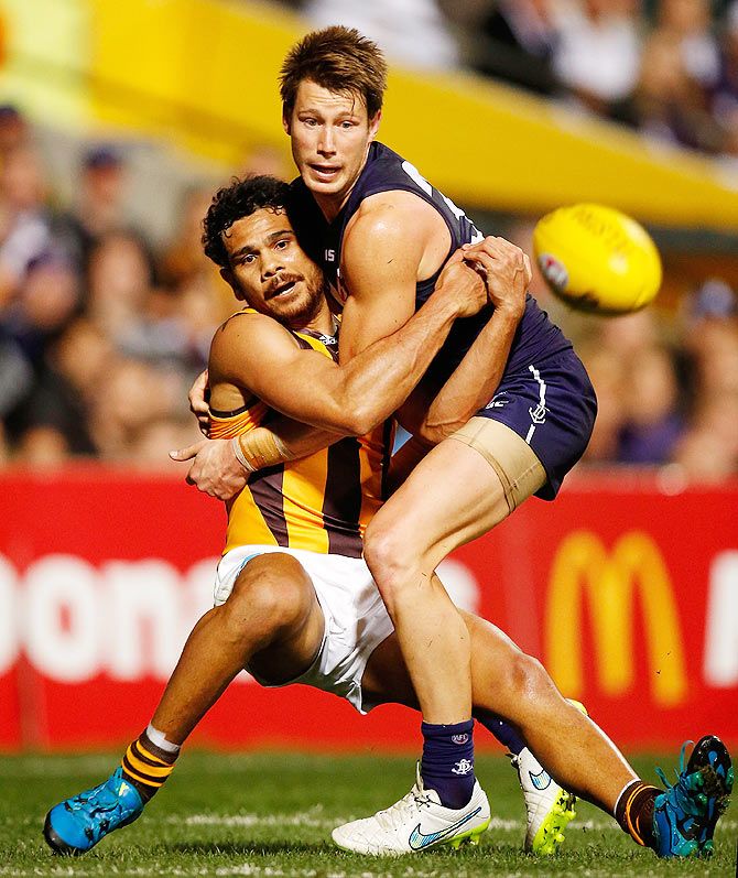 Cyril Rioli of the Hawks and Lee Spurr of the Dockers in action during the 2015 AFL First Preliminary Final match at Domain Stadium in Perth on Friday, September 25