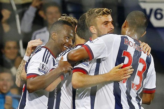 Saido Berahino celebrates with teammates after scoring the first goal for West Brom