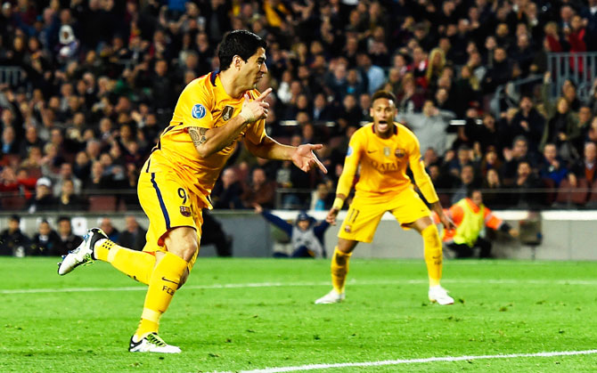 Barcelona's Luis Suarez celebrates as he scores their second goal with a header during the UEFA Champions League quarter-final first leg match against Atletico de Madrid at Camp Nou in Barcelona on Tuesday