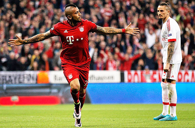 Bayern Munich's Arturo Vidal scores the opening goal against Benfica during their Champions League, quarter final first leg match at the Allianz Arena in Munich on Tuesday
