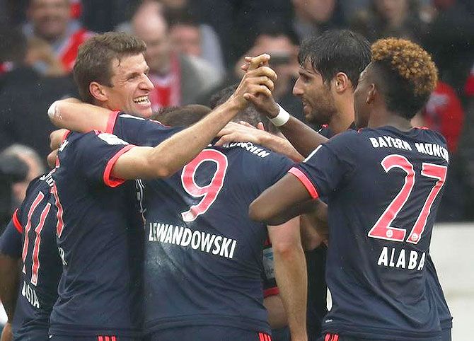 Bayern Munich's Douglas Costa celebrates with his teammates after scoring a goal against Stuttgart during their Bundesliga match at Mercedes-Benz Arena in Stuttgart on Sunday.