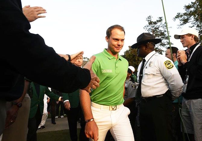 Danny Willett walks to the green jacket ceremony after winning the 2016 The Masters golf tournament at Augusta National Golf Club on Sunday