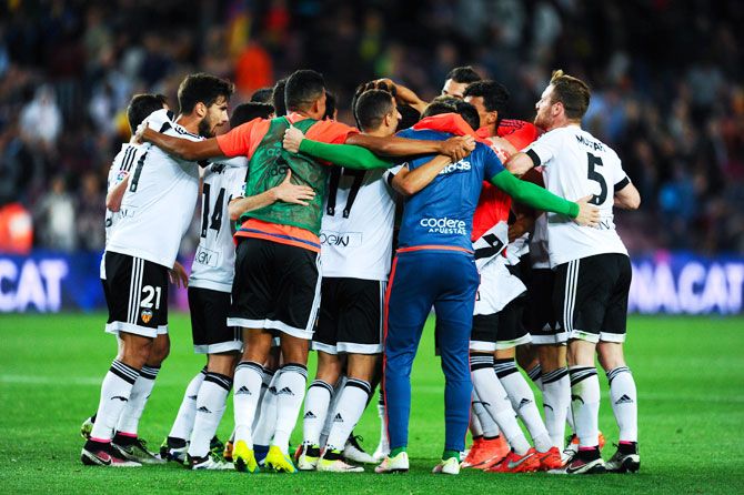 Valencia CF players celebrate after defeating FC Barcelona on Sunday