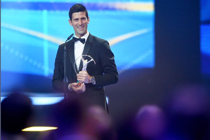 Tennis player Novak Djokovic of Serbia accepts his Laureus World Sportsman of the Year trophy 