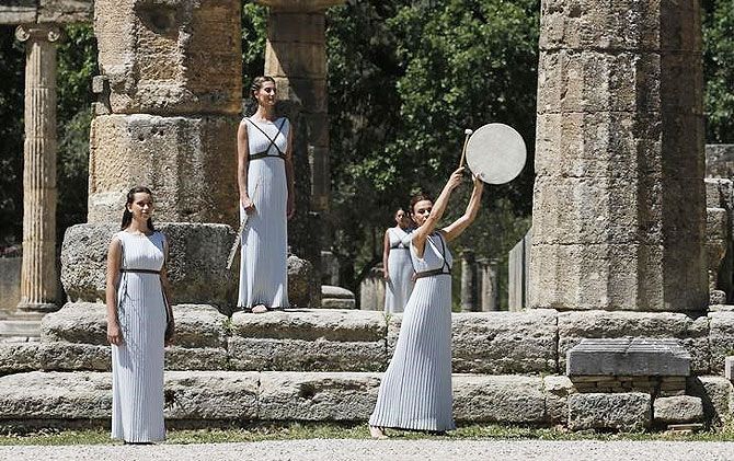 Priestesses attend the Olympic flame lighting ceremony for the Rio 2016 Olympic Games inside the ancient Olympic Stadium on the site of ancient Olympia, Greece, on Thursday