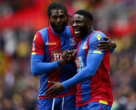 Emmanuel Adebayor (left) and Bakary Sako of Crystal Palace celebrate their team's victory following The Emirates FA Cup semi-final against Watford on Sunday