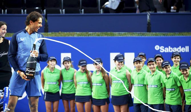 Spain's Rafael Nadal sprays cava as he celebrates victory after defeating Japan's Kei Nishikori to win the Barcelona Open on Sunday