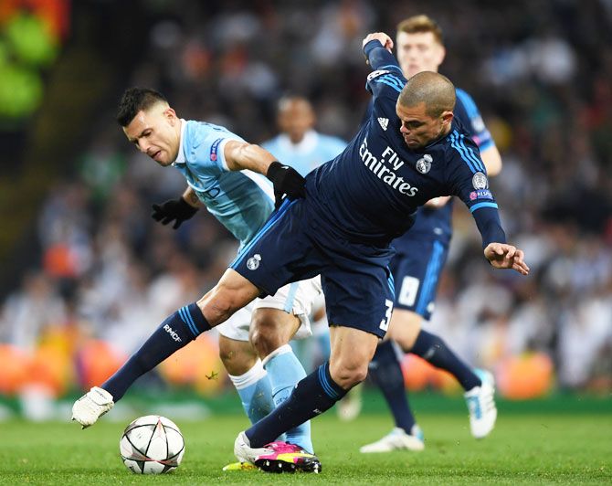 Manchester City's Sergio Aguero and Real Madrid's Pepe battle for possession during their UEFA Champions League semi-final first leg match at the Etihad Stadium in Manchester on Tuesday