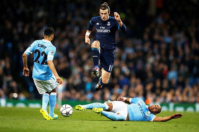 Real Madrid's Gareth Bale is tackled by Manchester City's Fernando and Gael Clichy during their UEFA Champions League semi-final first leg match at Etihad Stadium in Manchester on Tuesday