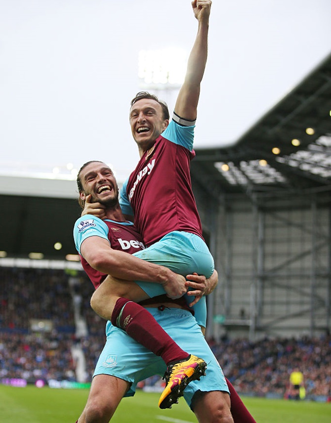 West Ham United’s Mark Noble, right, celebrates scoring his team's third goal with his teammate Andy Carroll 