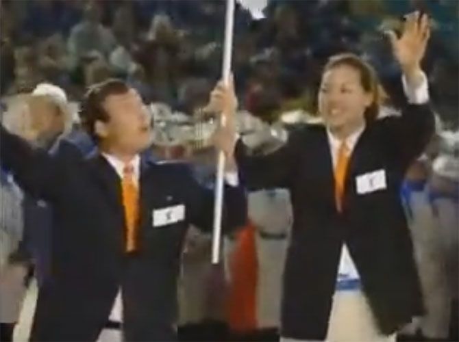 South Korean basketballer Chung Un Soon, right, and North Korean judo coach Park Chong Chul were joint flag-bearer at the 2000 Olympic Games