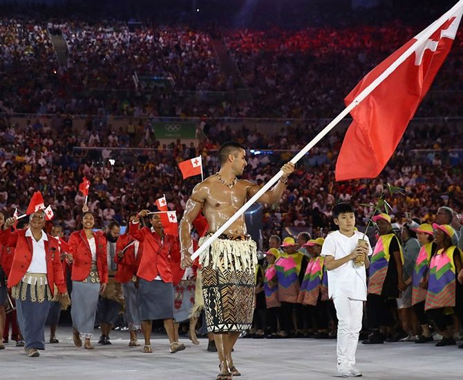 Pita Nikolas Aufatofua of Tonga carries the flag during the Opening Ceremony