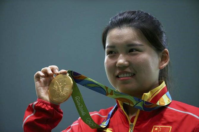 China's Zhang Mengxue poses with her gold medal on the podium after winning the Women's 10m Air Pistol event at the Olympic Shooting Centre in Rio de Janeiro on Sunday