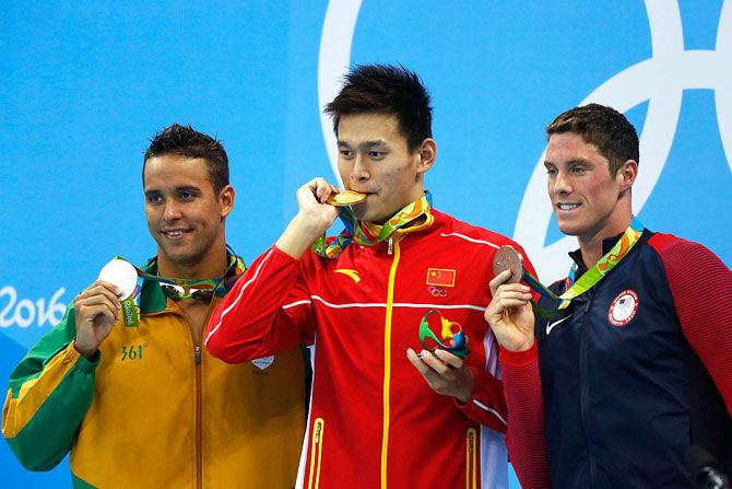 Silver medalist Chad le Clos of South Africa, gold medalist Yang Sun of China and bronze medalist Conor Dwyer of the United States pose on the podium during the medal ceremony for the Men's 200m Freestyle Final on Day 3 of the Rio 2016 Olympic Games at the Olympic Aquatics Stadium in Rio de Janeiro, Brazil, on Monday