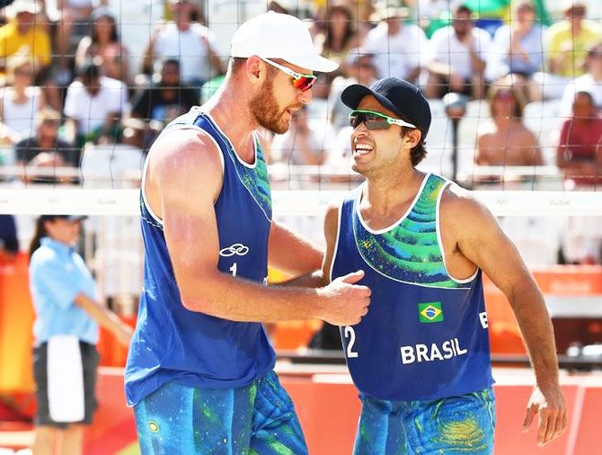 Alison of Brazil and Bruno Oscar Schmidt react during their match