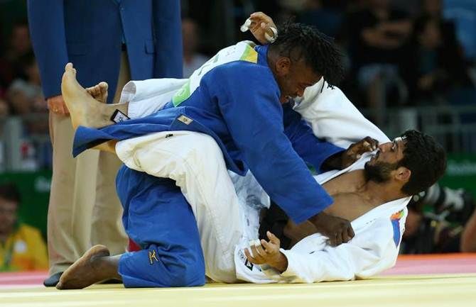 India’s Avtar Singh, in white, is at the receiving end from Misenga Popole of the Refugee Olympic Team in the men's judo 90kg elimination Round of 32 at the Rio Olympics on Wednesday