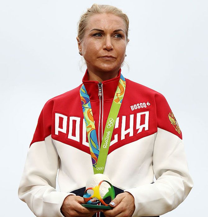 Silver medalist Olga Zabelinskaya of Russia stands on the podium at the medal ceremony for the Cycling Road Women's Individual Time Trial on Wednesday