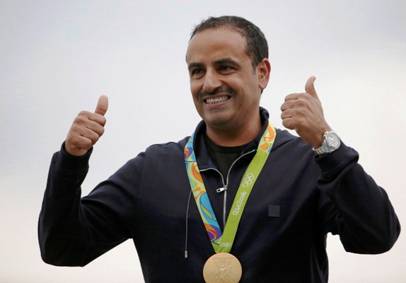 Fehaid Aldeehani of Independent Olympic Athlete poses with his men's double trap gold medal