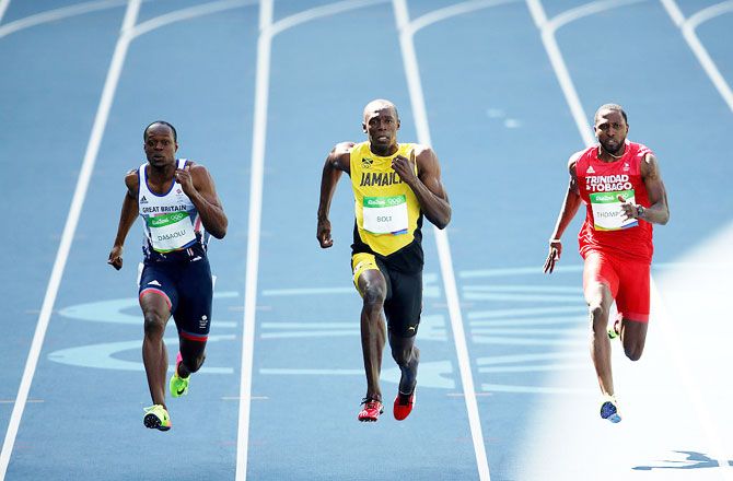 Jamaica's Usain Bolt, Trinidad and Tobago's Richard Thompson and Great Britain's James Dasaolu compete in the Men's 100m Round 1 heats at the Olympic Stadium in Rio de Janeiro on Saturday