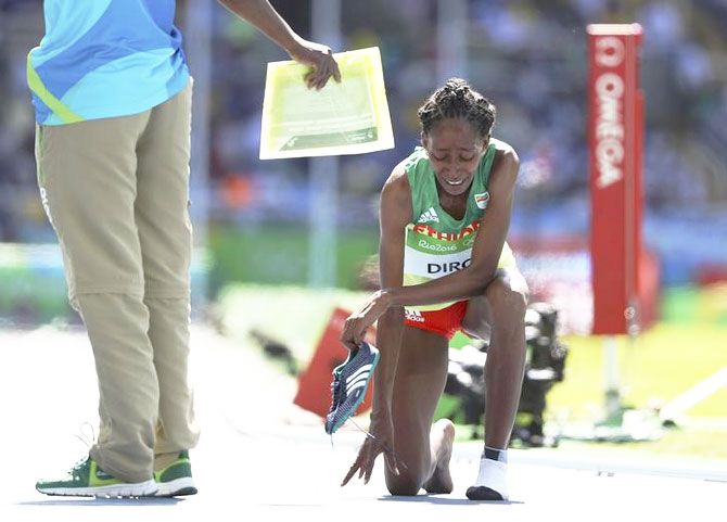 Ethiopia's Etenesh Diro reacts after she competed most of the 3000m Steeplechase race without one shoe