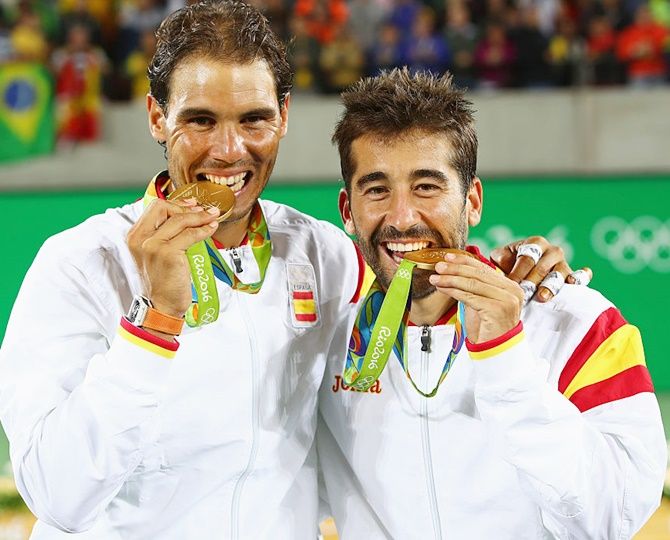 Gold medalists Rafael Nadal and Marc Lopez of Spain celebrate with their medals after the men's doubles gold medal match on Day 7 of the Rio 2016 Olympic Games