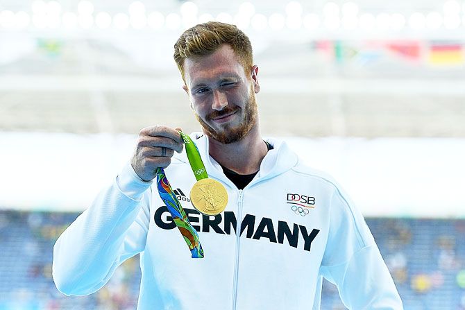 Gold medalist Christoph Harting of Germany poses on the podium during the medal ceremony for the Men's Discus Throw Final on Saturday