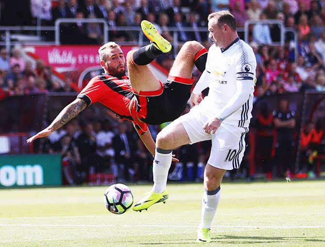 Manchester United's Wayne Rooney challenges AFC Bournemouth's Steve Cook