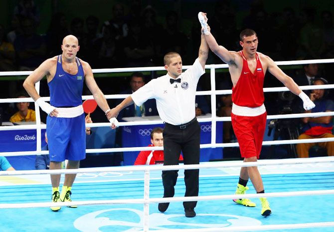 Evgeny Tishchenko of Russia reacts after winning his bout against Vassiliy Levit of Kazakhstan to win the Men's Heavy (91kg) gold medal on Monday