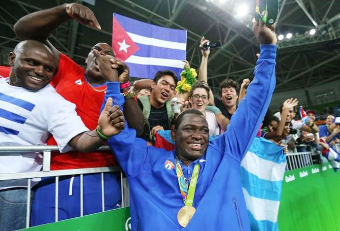 Mijain Lopez of Cuba celebrates with supporters after winning the gold medal in the Men's Greco-Roman 130 kg event on Monday