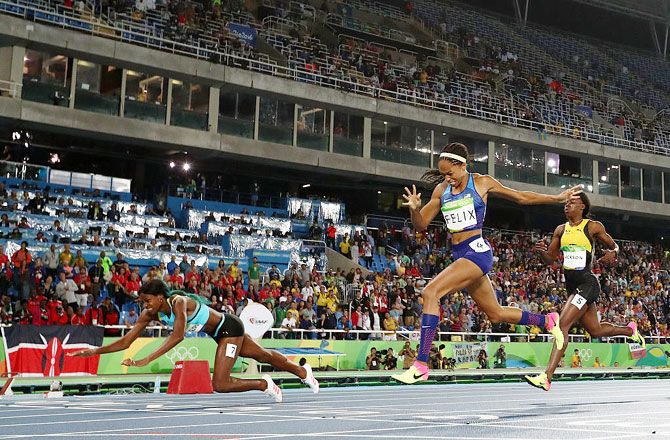 Shaunae Miller of the Bahamas (left) dives over the finish line ahead of silver medalist Allyson Felix of the United States (centre) and bronze medalist Shericka Jackson of Jamaica (right) to win the gold medal in the Women's 400m Final at the Rio 2016 Olympic Games at the Olympic Stadium on Monday