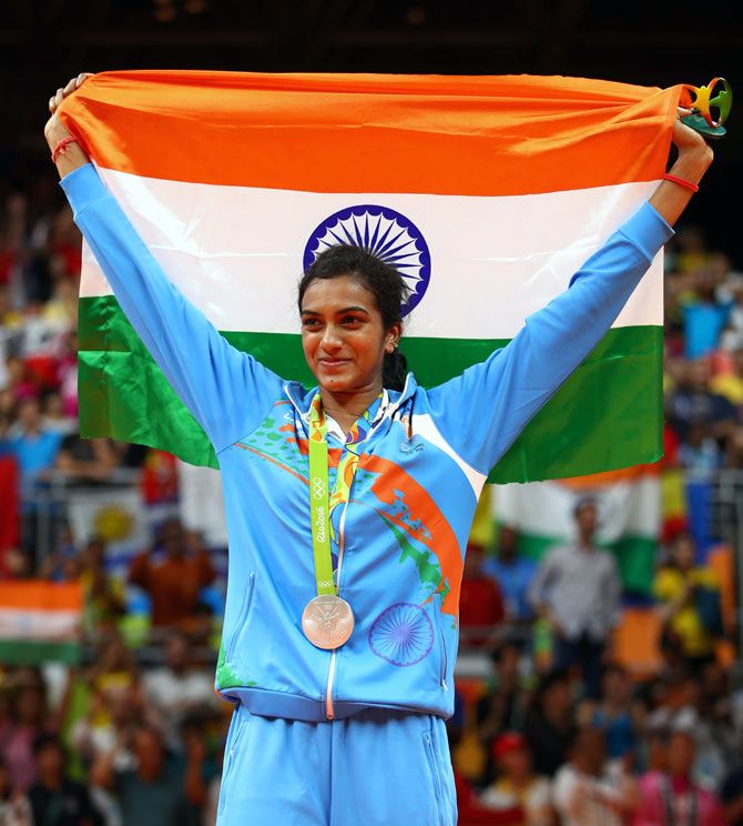 Silver medallist P V Sindhu of India celebrates during the medal ceremony after losing to Carolina Marin of Spain in the women's singles badminton final at the Rio Olympics