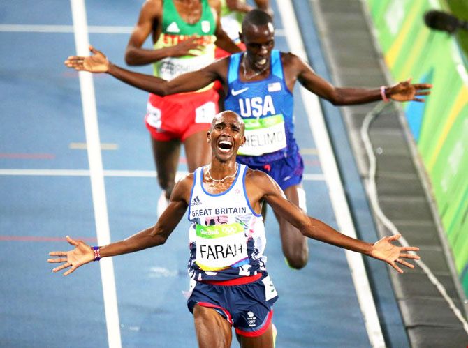 Mo Farah of Britain celebrates winning the 5000m race at Olympic Stadium on Saturday