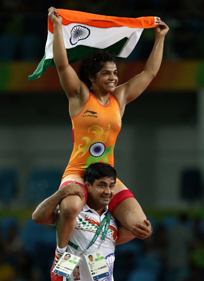 Sakshi Malik celebrates with her coach Kuldeep Malik after winning bronze medal in the women's Freestyle 58 kg Bronze match on Day 12 of the Rio 2016 Olympic Games. Photograph: Lars Baron/Getty Images