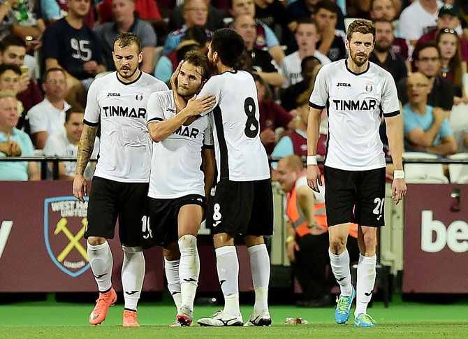 Filipe Teixeira of FC Astra Giurgiu celebrates with teammates after scoring the opening goal against West Ham United during their UEFA Europa League match at the Olympic Stadium in London on Thursday