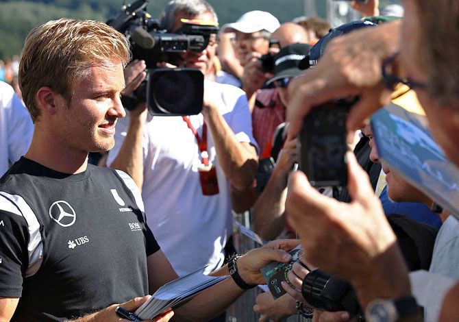 Mercedes GP's Germany driver Nico Rosberg signs autographs for fans during previews ahead of the Formula One Grand Prix of Belgium at Circuit de Spa-Francorchamps in Spa, Belgium, on Thursday