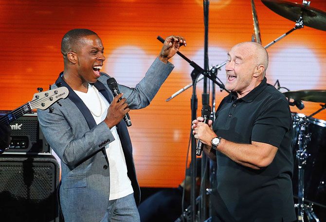 British singer Phil Collins (right) and American actor and singer Leslie Odom, Jr. perform 'Easy Lover' during opening ceremony on Day 1 of the 2016 US Open on Monday